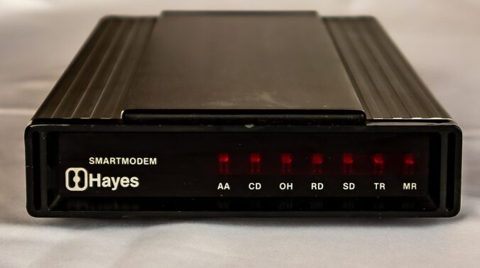 A dial-up modem from 1982, the Hayes Smartmodem. A small black box with blinking lights on the front.